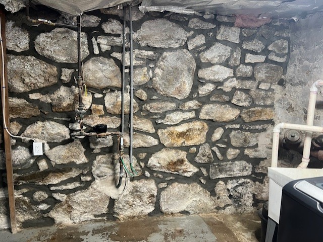 tuckpointing services for interior wall of stone foundation in Stamford, CT