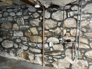 tuckpointing services for interior wall of stone foundation in Stamford, CT